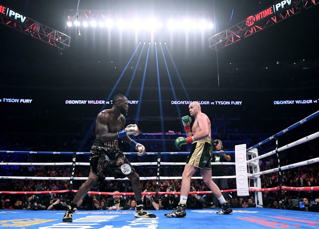 Tyson Fury promises second-round knockout against undefeated Deontay Wilder in February rematch. Image via Business Insider.