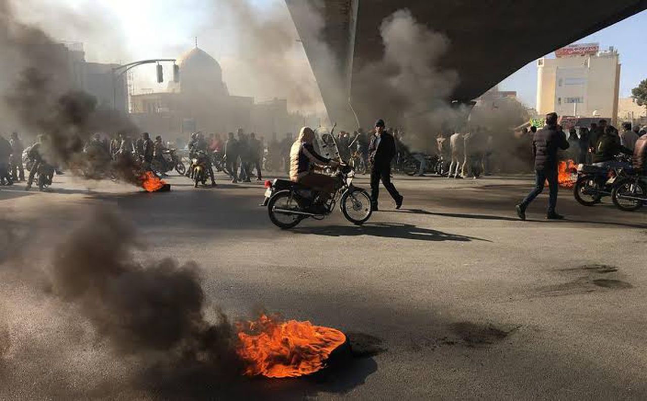People in Iran are still protesting the rise in fuel prices, image via AFP