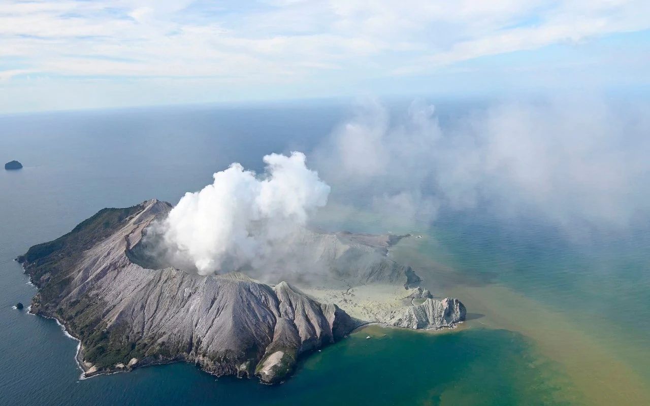 White Island volcano erupts in New Zealand, group of people on the island may have suffered injuries. Image via AP.