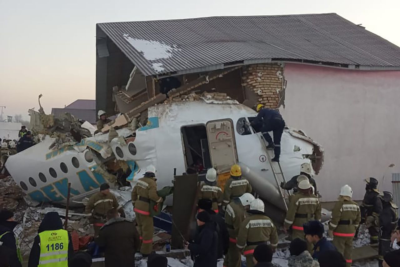 Several rescue personnel digging through the wreckage of the Bek aircraft. Image via Independent.co. 