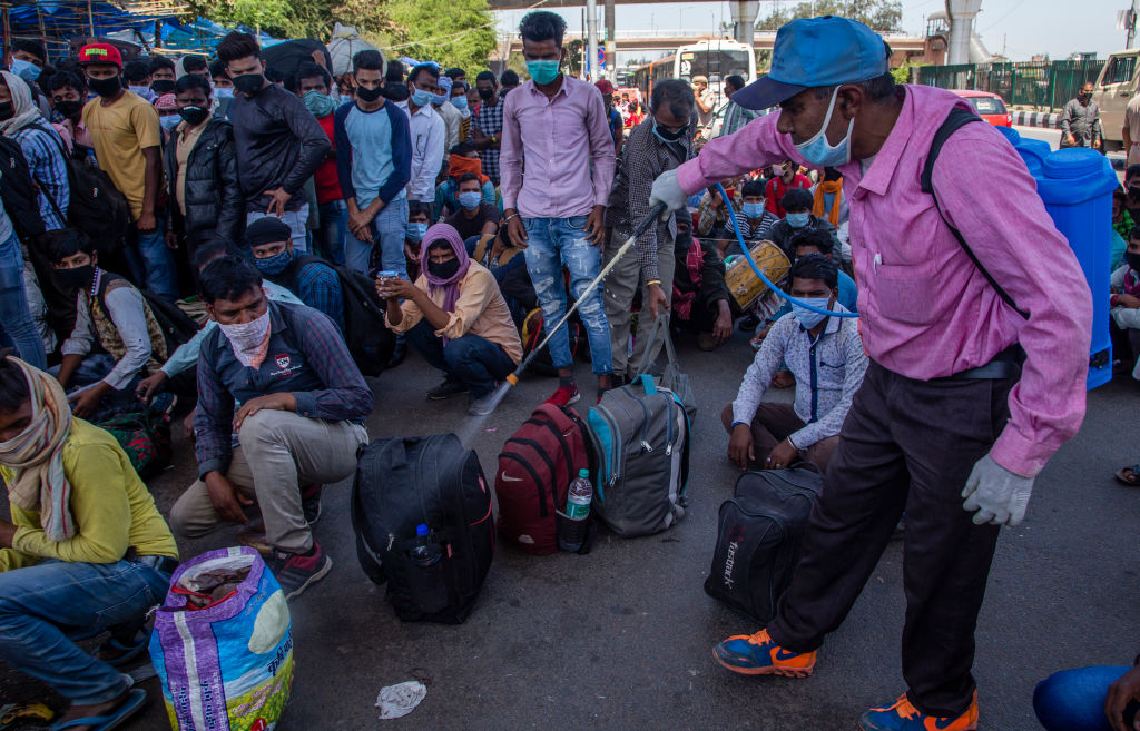 Indian migrant workers doused in a Chemical solution