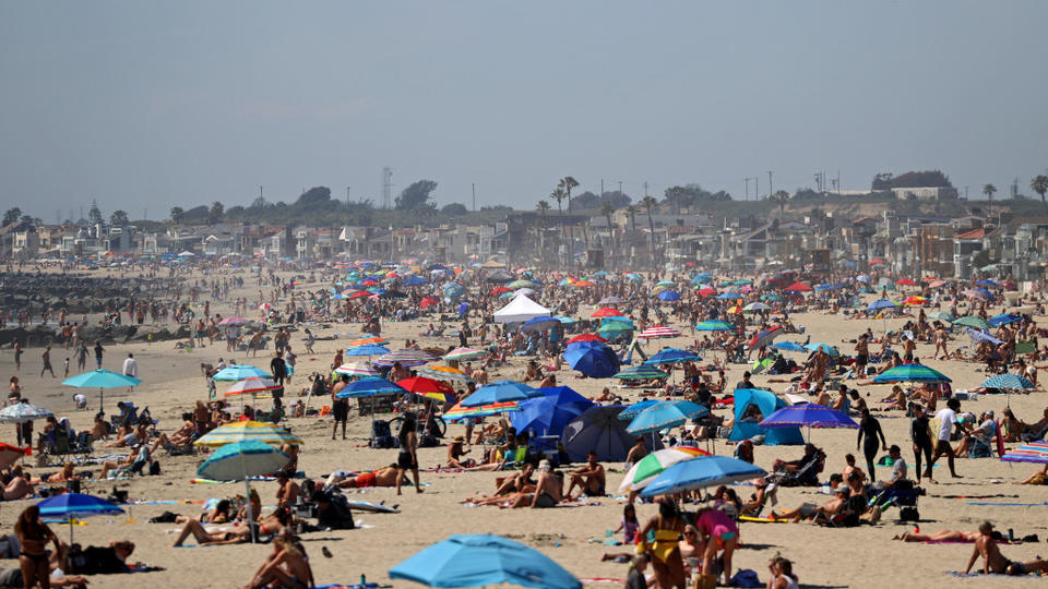 Thousands flock to California beaches, defying stay-at-home orders