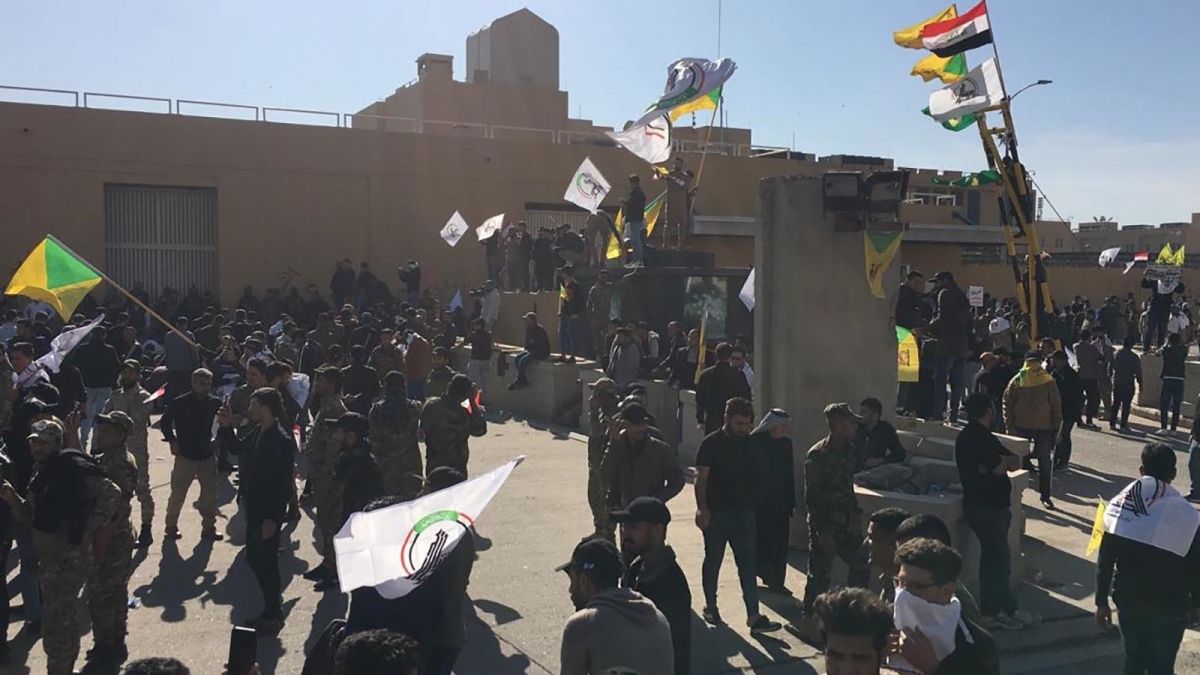 Hashd Shaabi supporters march on US embassy in Baghdad after airstrikes kill 25 fighters. Image via CNN.